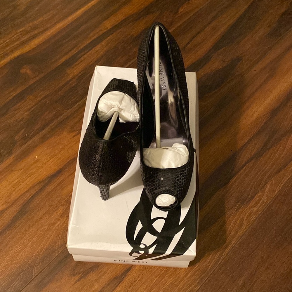Shine all night in Nine West’s black sequin platform peep-toe heels—pure glamour
